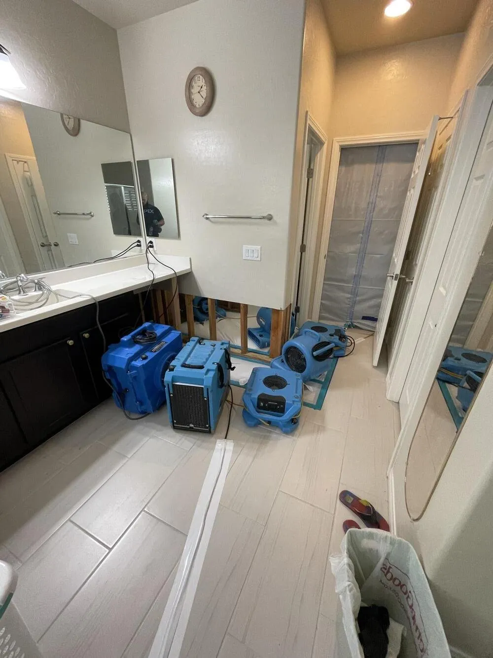 Air movers and dehumidifiers drying a bathroom floor, water damage restoration in Sunrise Manor, NV