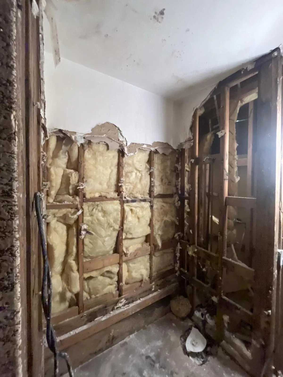 Bathroom walls stripped to the studs and insulation, water damage restoration in Sunrise Manor, NV
