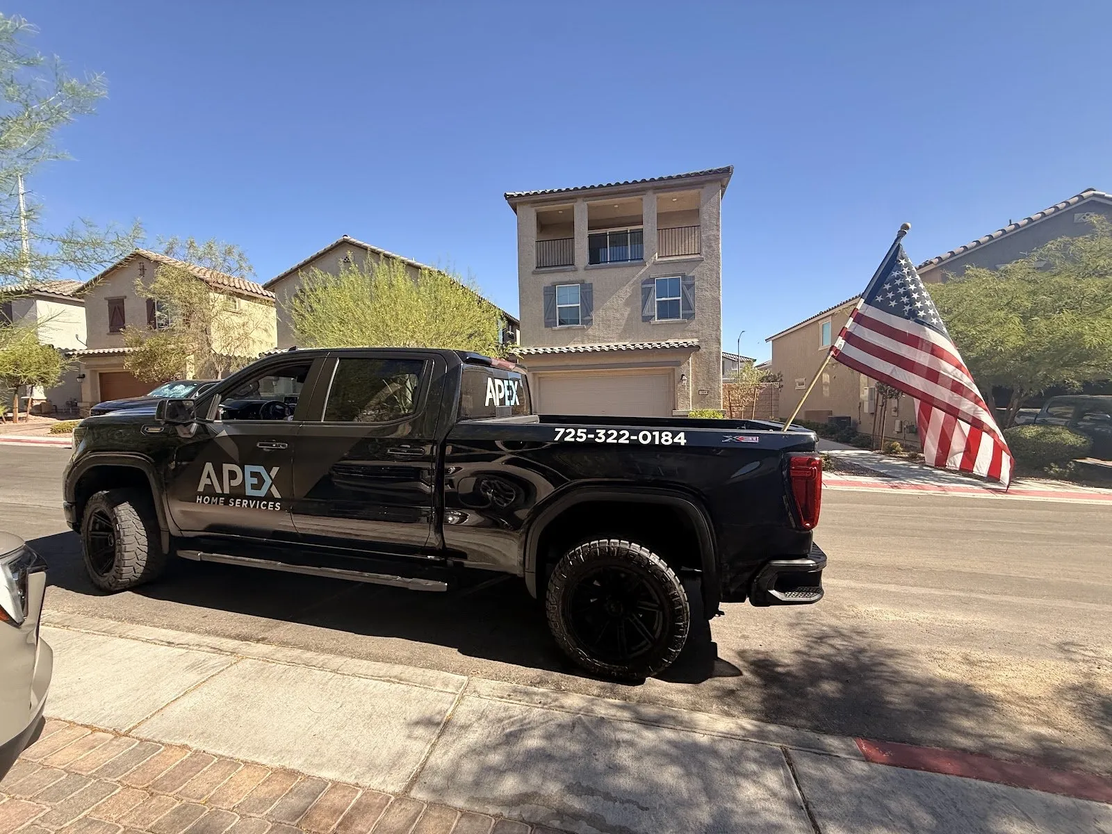 Apex Home Services pickup parked on a residential street, water damage restoration in Henderson, NV