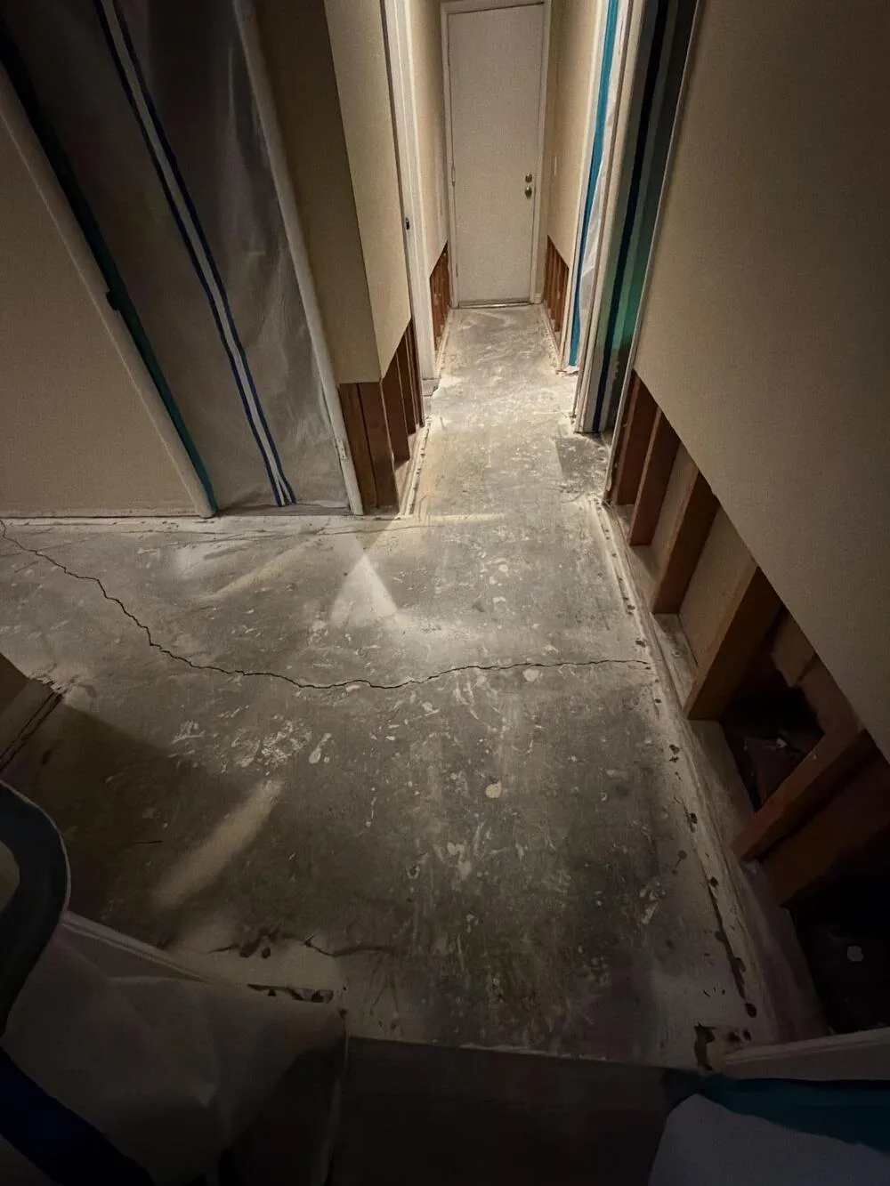 Hallway stripped to the concrete slab with the lower walls cut away, flood cleanup from Apex Home Services in Las Vegas