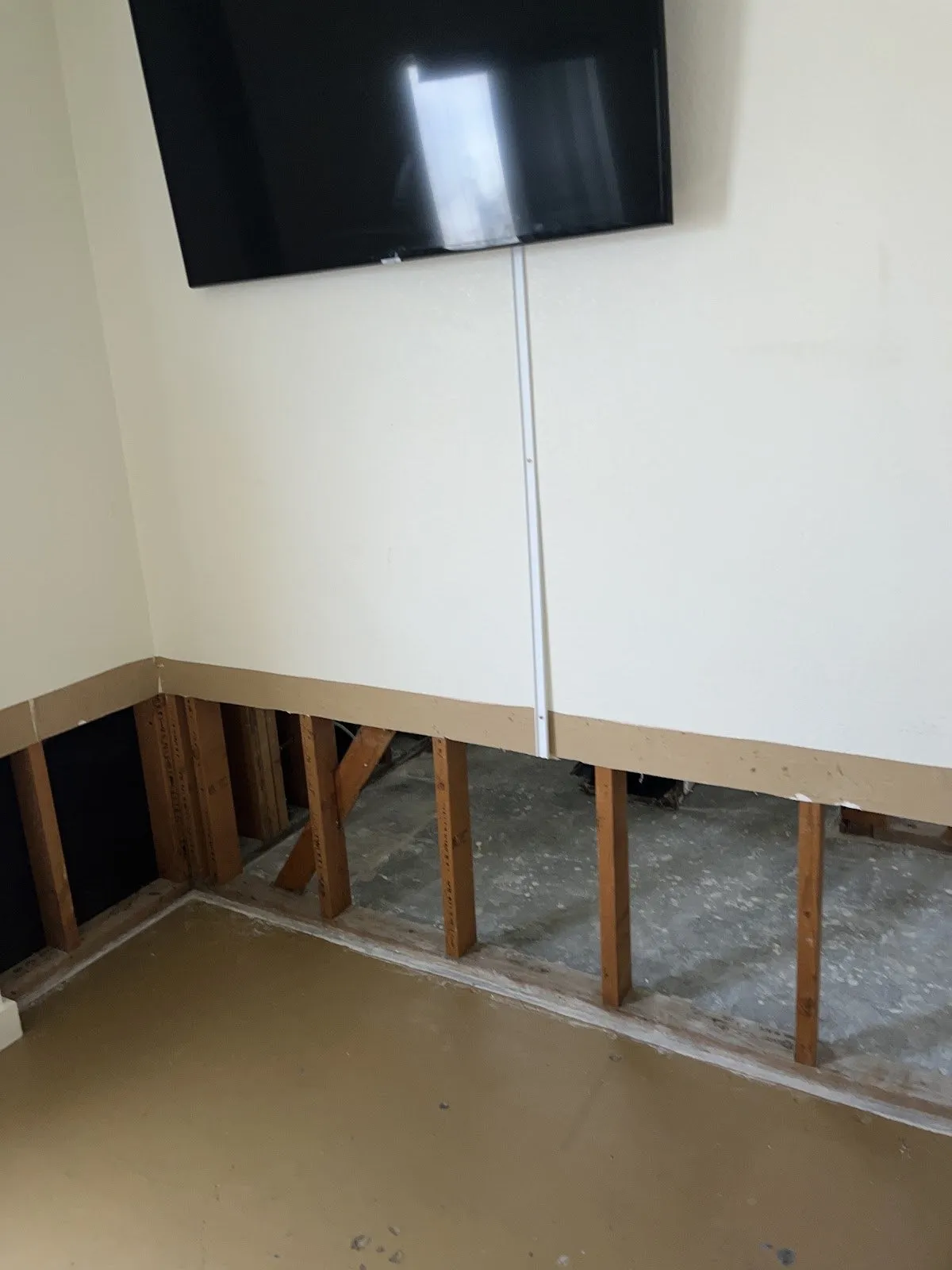 Living room with the lower drywall cut away and the studs exposed, flood cleanup in Las Vegas
