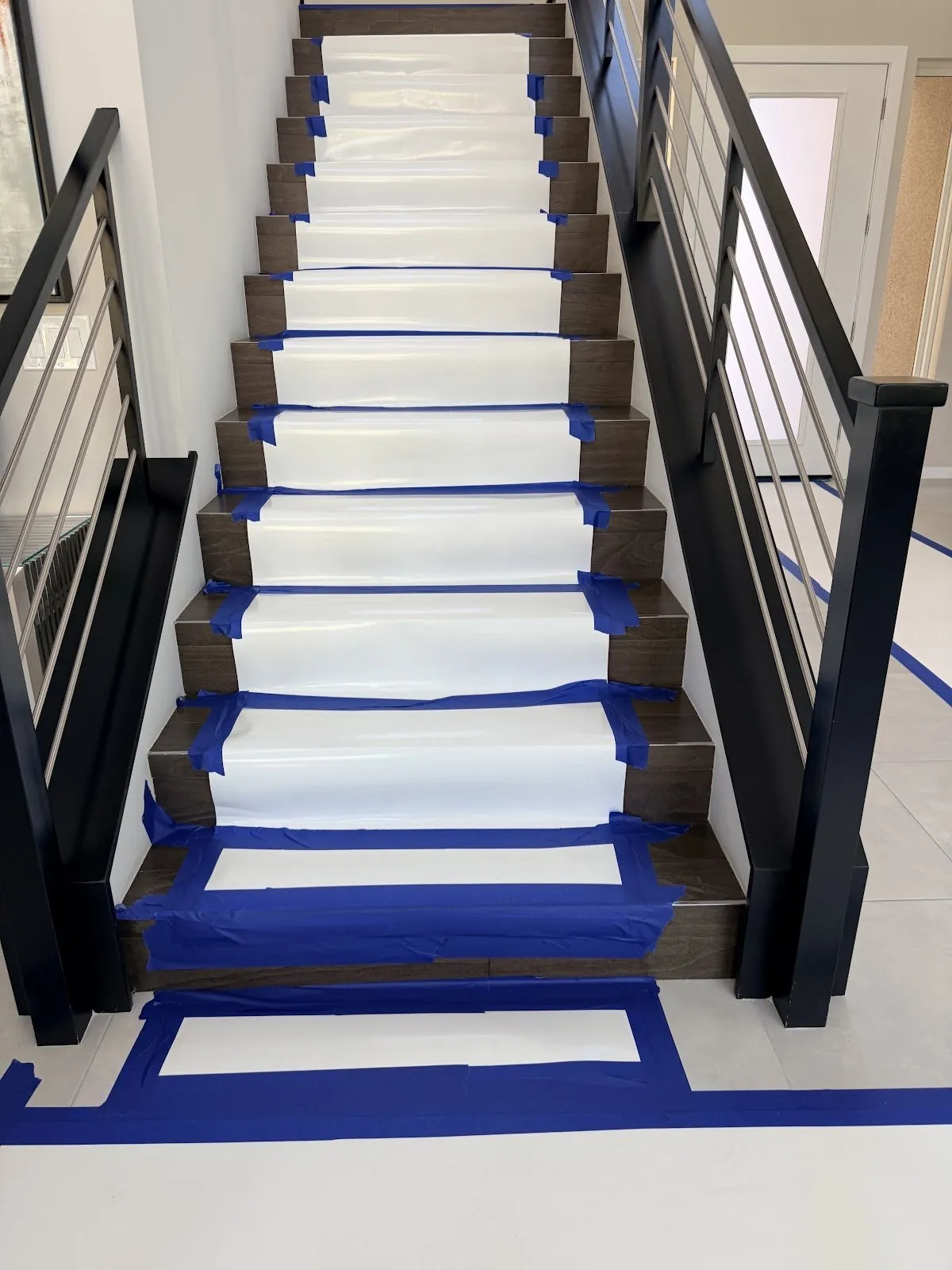 Staircase with every tread covered and taped to protect it during the job, water extraction in Las Vegas