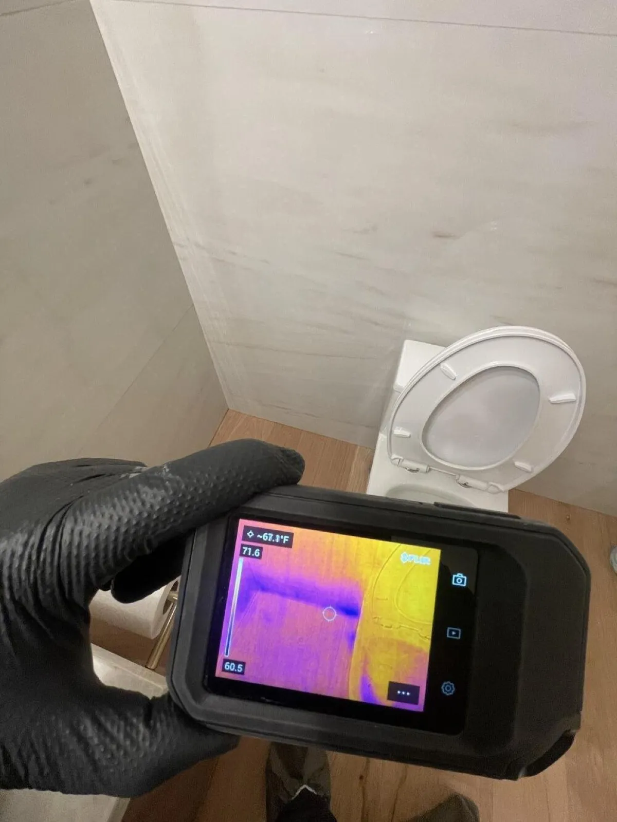 Thermal camera reading a bathroom wall beside the toilet, water damage restoration in Boulder City, NV