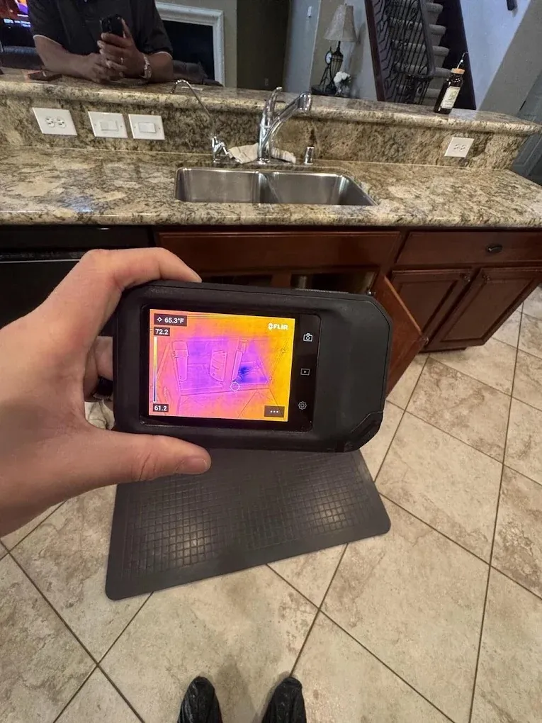 Thermal camera showing a cold, wet spot under a kitchen sink cabinet, water damage restoration in Las Vegas