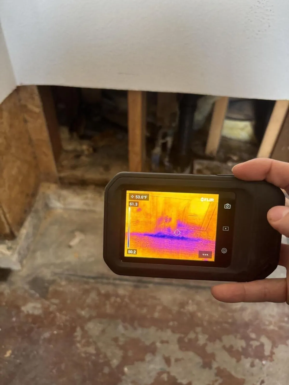 Thermal camera showing a cold, wet band at the base of an opened wall, water damage restoration in Centennial Hills, NV